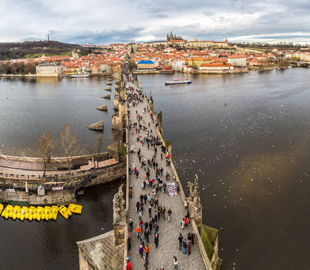 PRAGUE, CZECH REPUBLIC - DECEMBER 21: Tourists on Charles Bridge, December 21, 2013, Prague,Czech Republic. Annually Prague is visited by more than 3,5 million touristsのeditorial素材