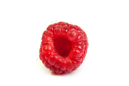 Single fresh sweet raspberry. Isolated over white background. Close up macro shot. Image was professionally retouchedの写真素材