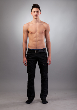 Handsome face of a young man. Isolated on grey background.の写真素材