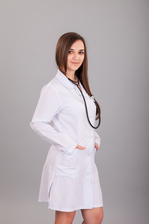 Young and beautiful nurse isolated on a grey backgroundの写真素材