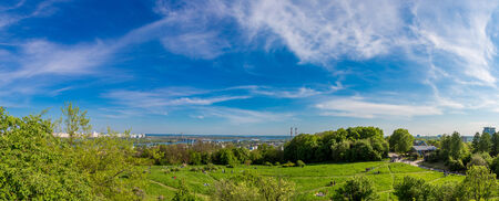 panorama of city landscape and nature. Kiev, Ukraine. Green trees, architecture, and blue riverの写真素材