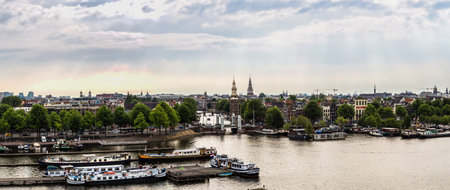 AMSTERDAM, NETHERLANDS - AUGUST 19: Canal and bridge in Amsterdam. Amsterdam is the capital and most populous city of the Netherlands on August 19, 2014のeditorial素材