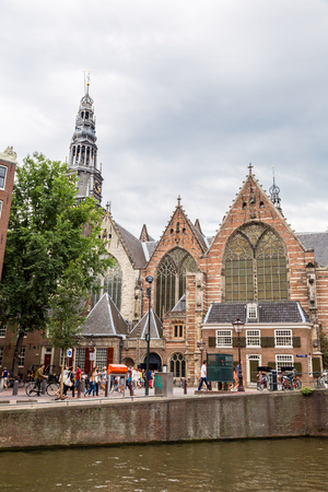 AMSTERDAM, NETHERLANDS - AUGUST 19: Oude Kerk (Old Church) and Voorburgwal canal in Amsterdam on August 19, 2014のeditorial素材