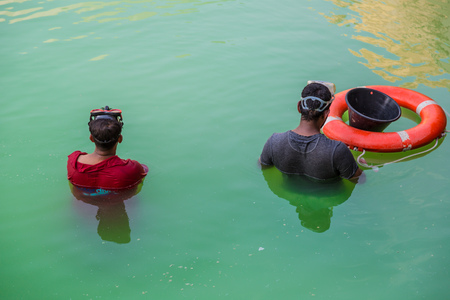 DUBAI, UAE - APRIL 29: Workers in uniform are cleaning pool on April 29, 2013 in Dubai.のeditorial素材