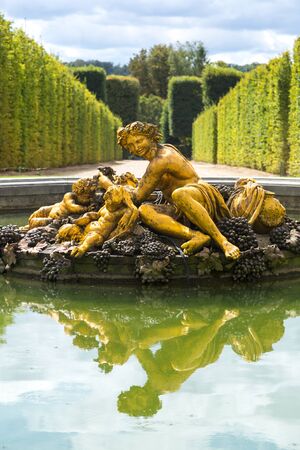 VERSAILLES, FRANCE - August 7, 2014: Fountain in the gardens of the Versailles Palace in a beautiful summer day in France on August 7, 2014, France.のeditorial素材