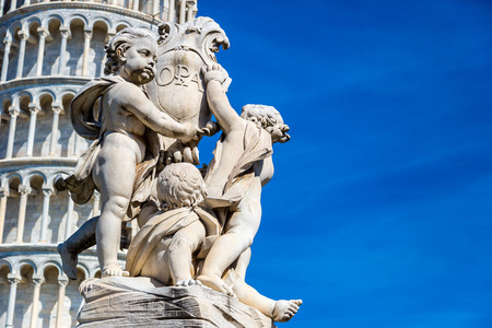 Leaning  tower in Pisa with statue of angels   in a summer day in Italyの写真素材
