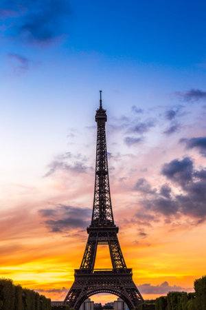 Eiffel Tower at sunset is the most visited monument in France and the most famous symbol of Paris
