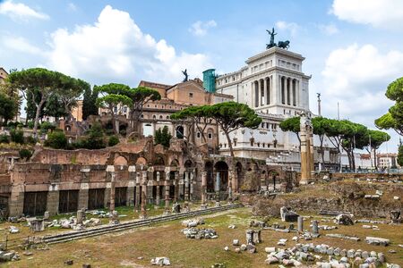 Ancient ruins of Forum and Victor Emmanuel II monument in a summer day in Rome, Italyの写真素材