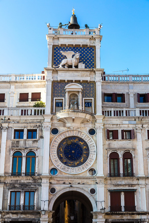 Astronomical clock tower with signs in a summer day in Venice, Italyの写真素材