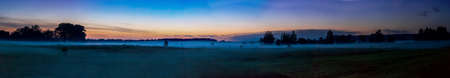 Beautiful sunrise over green field in a summer morningの写真素材
