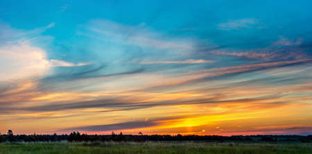 Beautiful sunrise over green field in a summer morningの写真素材