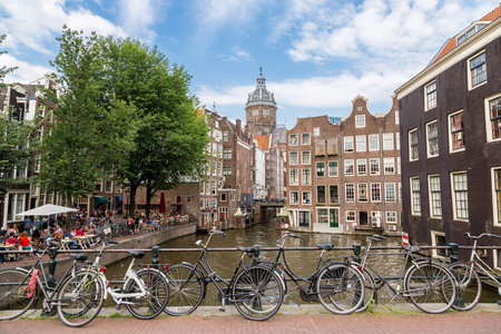 Bicycles on a bridge over the canals of Amsterdam in a summer day, Netherlandsの写真素材