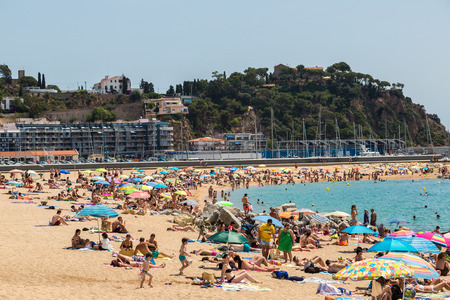 BLANES, SPAIN - JUNE 26, 2016: Tourists enjoy at the beach in Blanes in Costa Brava in a beautiful summer day, Spain on June 26, 2016のeditorial素材