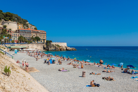 NICE, FRANCE - JUNE 21, 2016: Public beach in Nice in a beautiful summer day, France on June 21, 2016のeditorial素材