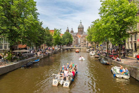 AMSTERDAM, THE NETHERLANDS - JUNE 16, 2016: Canal in Amsterdam in a beautiful summer day. Amsterdam is the capital and the most populous city of the Netherlands on June 16, 2016のeditorial素材
