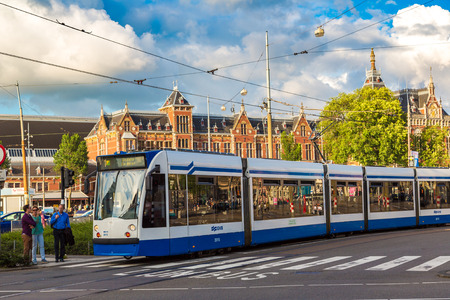 AMSTERDAM, THE NETHERLANDS - JUNE 16, 2016: City tram in Amsterdam in a beautiful summer 

day, The Netherlands on June 16, 2016のeditorial素材