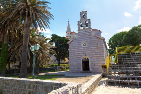 Holy Trinity church in old town in Budva in a beautiful summer day, Montenegroの写真素材