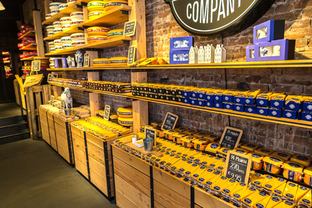 AMSTERDAM, THE NETHERLANDS - JUNE 16, 2016: Cheese wheels on the shelves in Amsterdam store, The Netherlands on June 16, 2016のeditorial素材