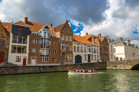BRUGES, BELGIUM - JUNE 14, 2016: Tourist boat on canal in Bruges in a beautiful summer day, Belgium on June 14, 2016のeditorial素材