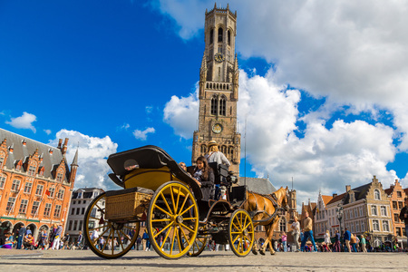 BRUGES, BELGIUM - JUNE 14, 2016: Horse carriage in the Market square in Bruges in a beautiful summer day, Belgium on June 14, 2016のeditorial素材