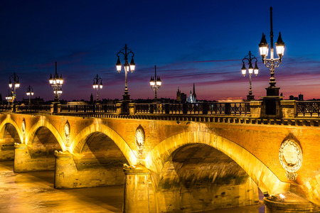 Pont de pierre, old stony bridge in Bordeaux in a beautiful summer night, Franceの写真素材