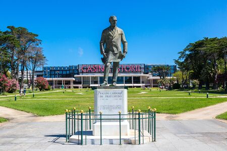 ESTORIL, PORTUGAL - JUNE 21, 2016: Statue of Fausto Cardoso and Casino Estoril in Estoril city in a beautiful summer day, Portugal on June  21, 2016のeditorial素材