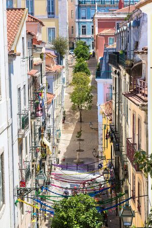 Old narrow street in Lisbon in a beautiful summer day, Portugalの写真素材