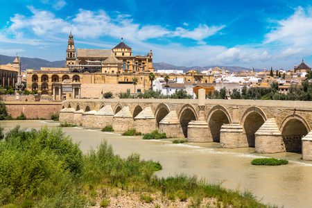 The Great Mosque (Mezquita Cathedral) and Roman Bridge on Guadalquivir river in Cordoba in a beautiful summer day, Spainの写真素材