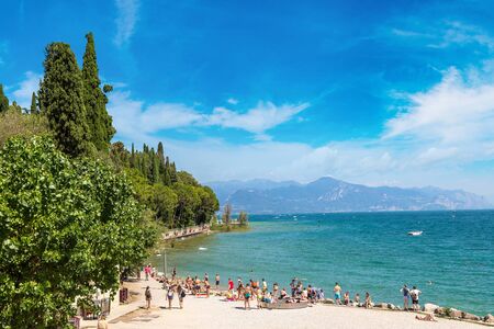 SIRMIONE, ITALY - JUNE 16, 2016: Garda lake, Public beach in Sirmione in a beautiful summer day, Italy on June 16, 2016のeditorial素材