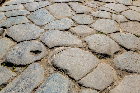 Stone road in Pompeii city destroyed in 79BC by the eruption of volcano Vesuvius, Italy in a beautiful summer dayの写真素材