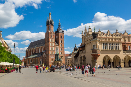 KRAKOW, POLAND - JUNE 23, 2016: Church of St. Mary and the Cloth Hall on the main market square in Krakow in a beautiful summer day, Poland on June 23, 2016のeditorial素材