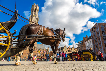 BRUGES, BELGIUM - JUNE 14, 2016: Horse carriage in the Market square in Bruges in a beautiful summer day, Belgium on June 14, 2016のeditorial素材