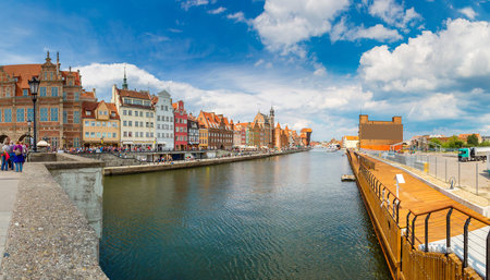 Tourist ship and colourful houses on Motlawa river in port of Gdansk, Baltic Sea, Poland in a summer...
