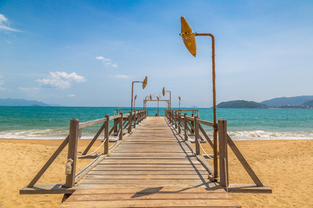 Wooden pier on city beach at Nha Trang, Vietnam in a summer dayの写真素材