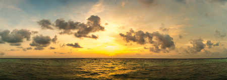 Beautiful sunset panorama at Maldives island in a summer eveningの写真素材