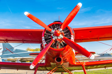 KIEV, UKRAINE - OCTOBER 6, 2018: Red biplane in Kiev National Aviation Museum in a sunny day next to...