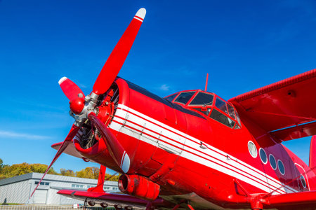 KIEV, UKRAINE - OCTOBER 6, 2018: Red biplane in Kiev National Aviation Museum in a sunny day next to...