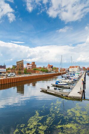 GDANSK, POLAND - JUNE 9, 2014: Tourist ship and colourful historic houses reflection Motlawa river in port of Gdansk,  Baltic Sea, Poland in a summer dayのeditorial素材