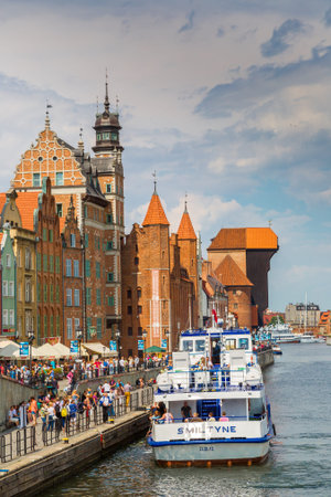 GDANSK, POLAND - JUNE 9, 2014: Tourist ship and colourful historic houses reflection Motlawa river...