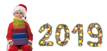 Boy holding a christmas box gift isolated on white background. 2019 New Year greeting