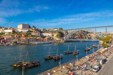 PORTO, PORTUGAL - JUNE 12, 2017: Traditional boats with wine barrels and Douro River in Porto in a beautiful summer day, Portugalのeditorial素材