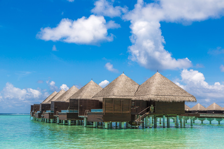 MALDIVES - JUNE 24, 2018: Water Villas (Bungalows) and wooden bridge at Tropical beach in the Maldives at summer dayのeditorial素材