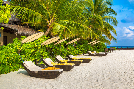 MALDIVES - JUNE 24, 2018: Wooden sunbed on tropical beach in the Maldives at summer dayのeditorial素材