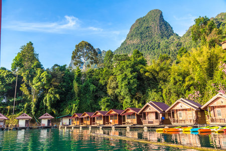 Traditional Thai bungalows at Cheow Lan lake, Ratchaprapha Dam, Khao Sok National Park in Thailand...