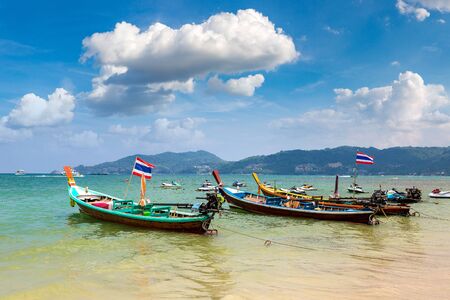 Traditional long tail boat on Patong beach and Andaman sea on Phuket in Thailand in a summer dayの写真素材