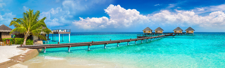 Panorama of Water Villas (Bungalows) and wooden bridge at Tropical beach in the Maldives at summer dayのeditorial素材