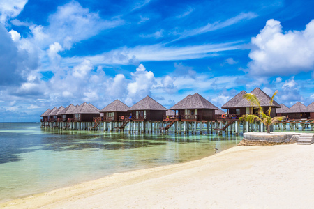 MALDIVES - JUNE 24, 2018: Water Villas (Bungalows) and wooden bridge at Tropical beach in the Maldives at summer dayのeditorial素材