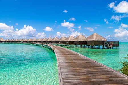 MALDIVES - JUNE 24, 2018: Water Villas (Bungalows) and wooden bridge at Tropical beach in the Maldives at summer dayのeditorial素材