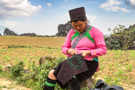 SAPA, VIETNAM - JUNE 19, 2018: Woman wearing traditional clothes at Terraced rice field in Sapa, Lao Cai, Vietnam in a summer dayのeditorial素材