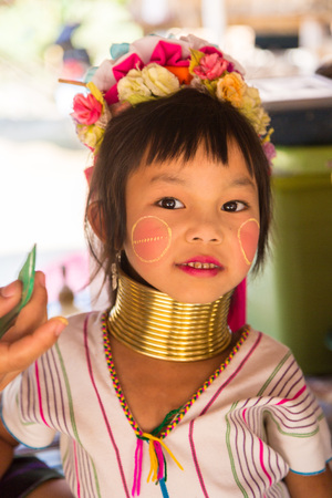CHIANG RAI, THAILAND - MARCH 29, 2018: Portrait of a long neck little girl in a village near Chiang Rai, Thailand in a summer dayのeditorial素材
